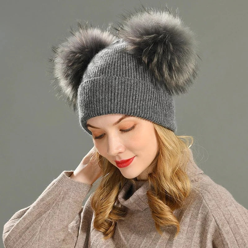 A woman wearing a grey fur hat designed by MVFURS