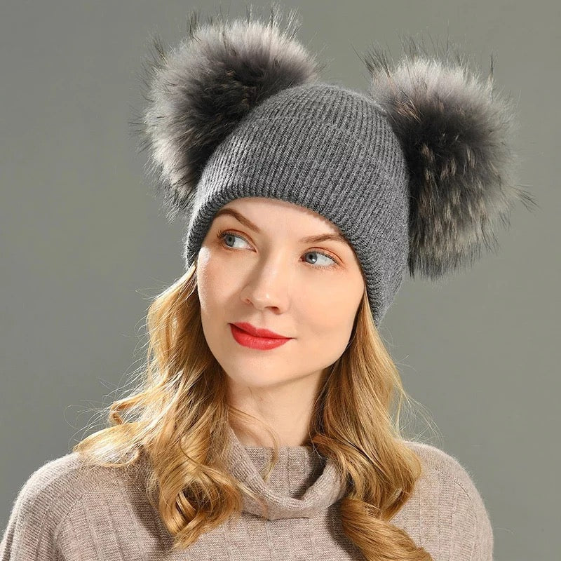 A woman wearing a grey fur hat designed by MVFURS