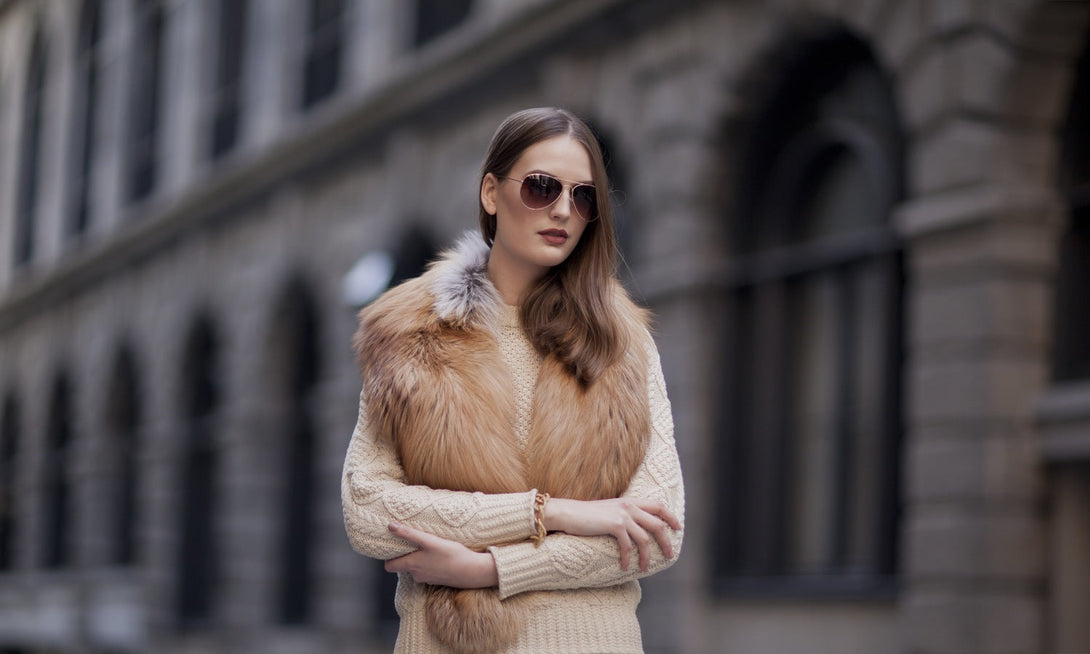 A woman wearing a golden fox fur collar designed by MVFURS