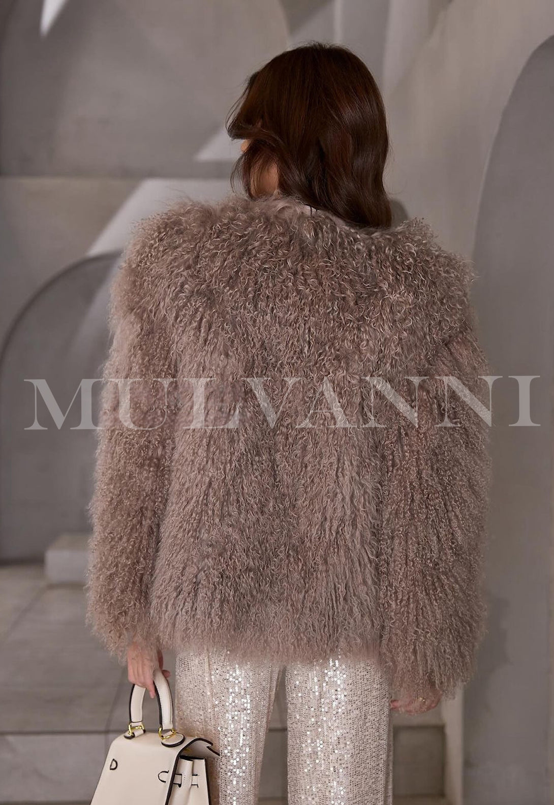 Elegant woman draped in a luxurious brown Mongolian coat perfect for a sophisticated look.