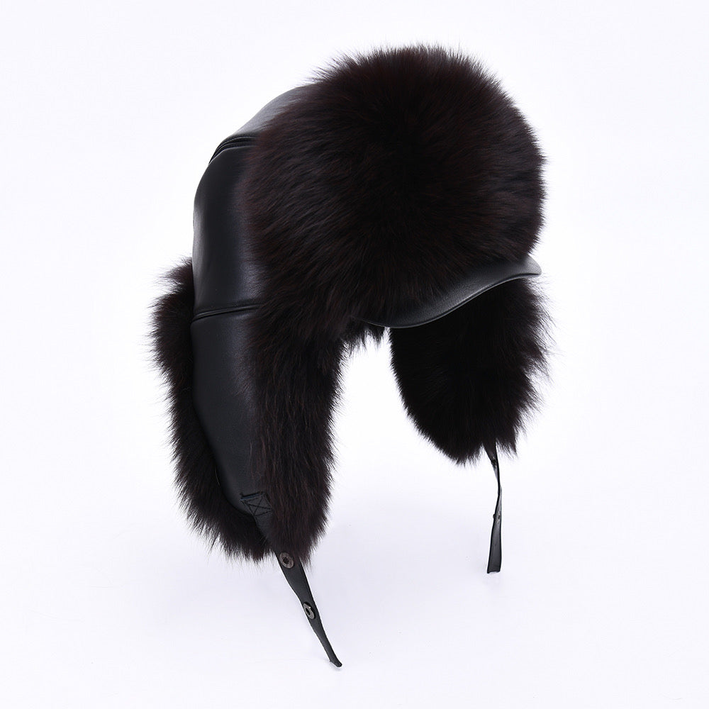 A women's black leather hat adorned with soft fox fur, featuring a structured design and a snug fit. The hat combines elegance and warmth, making it a stylish accessory for cold weather.