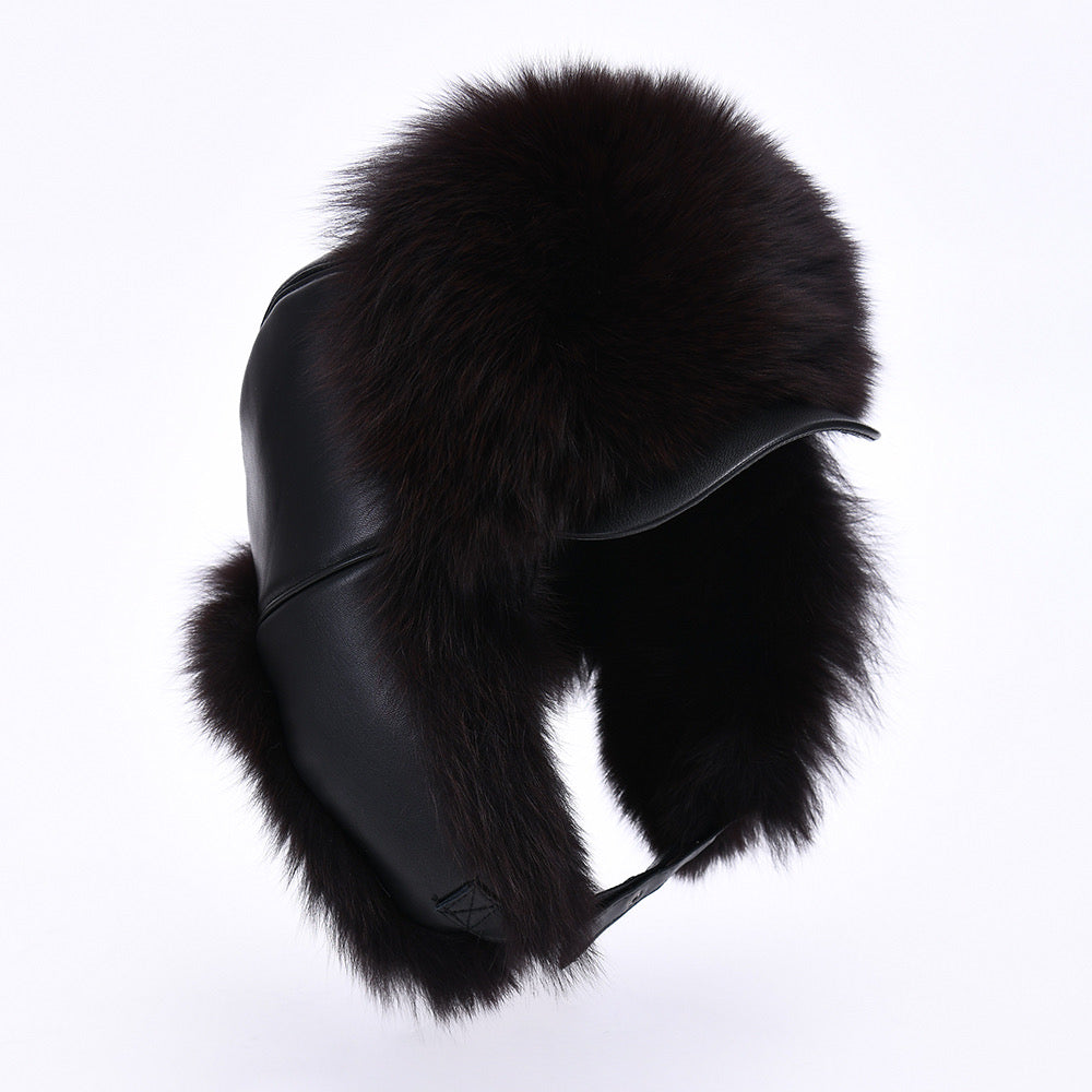 A chic black leather hat for women, featuring a luxurious fox fur trim that adds texture and warmth. The hat has a fitted design, perfect for elevating winter outfits with a touch of sophistication.