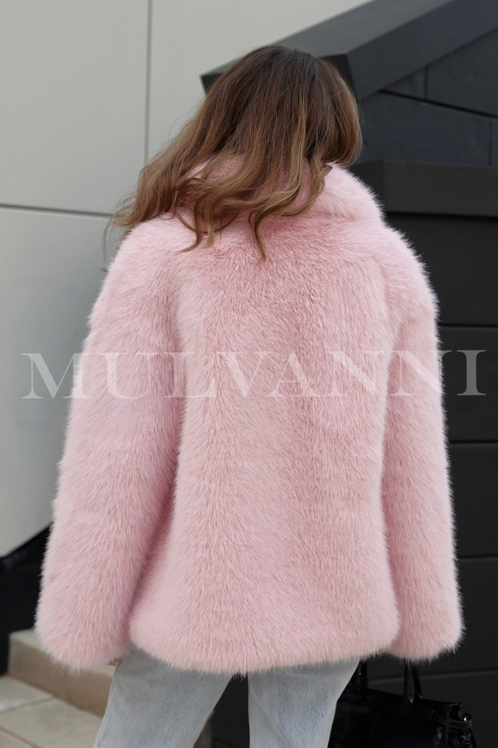 Women's pink faux fur coat with a soft, velvety finish and a cozy, oversized fit. The coat has a button-up front and a chic, relaxed design, making it an eye-catching piece for cold weather.