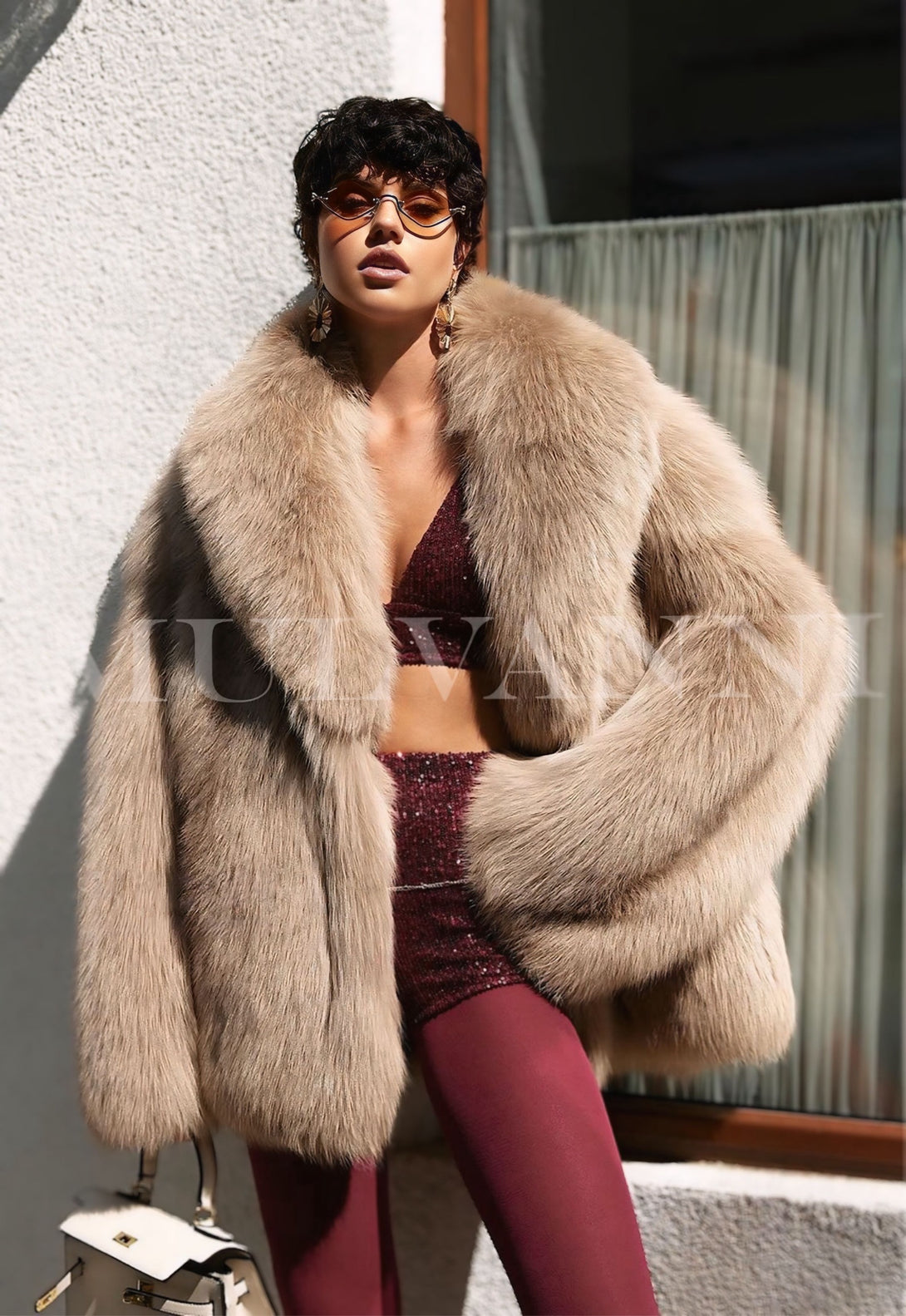 Stylish woman wearing ROMINA Faux Fur Coat in taupe, showcasing luxurious faux fur, elegant fashion statement.