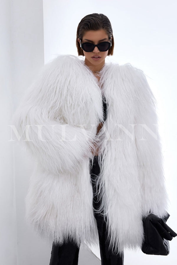 A woman wearing a luxurious white Mongolian coat, showcasing its unique texture and voluminous design, perfect for a bold winter look.