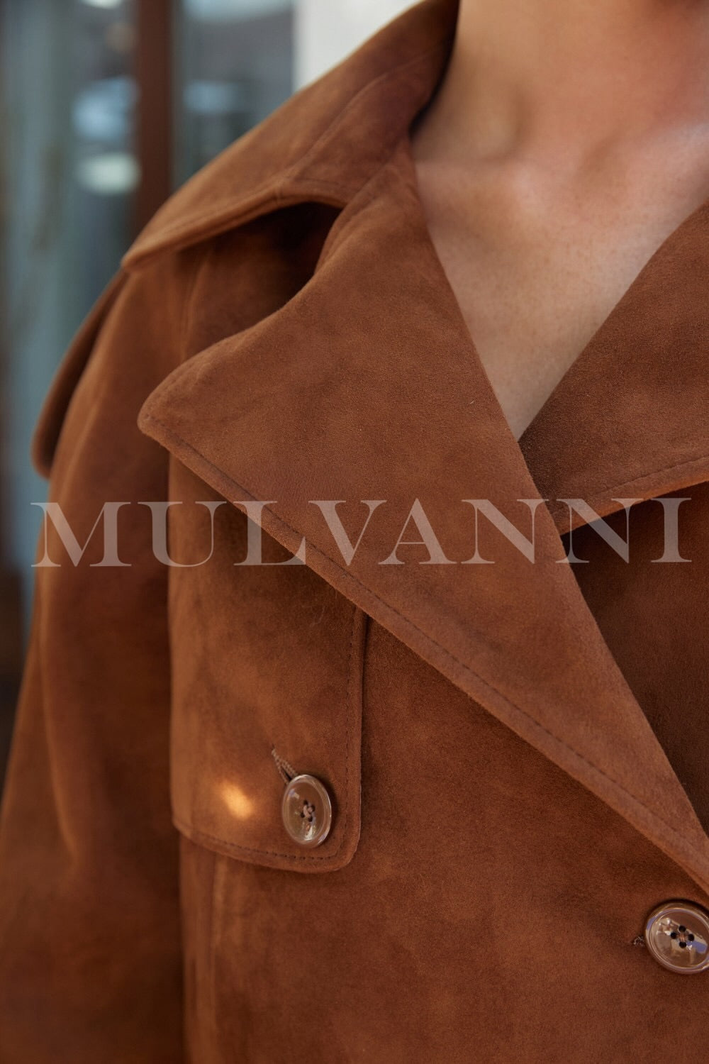 Close up of a brown suede jacket for woman.