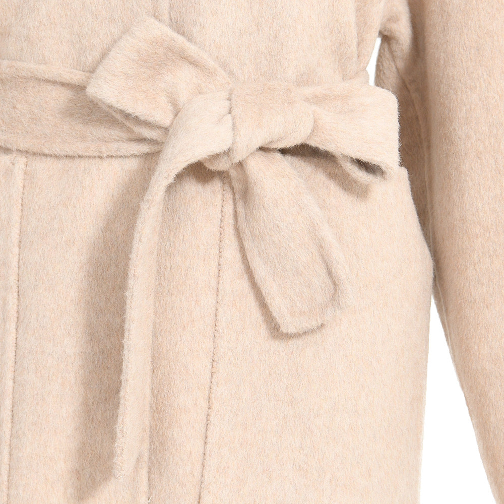 Close up of an ivory cashmere wool coat for woman. 