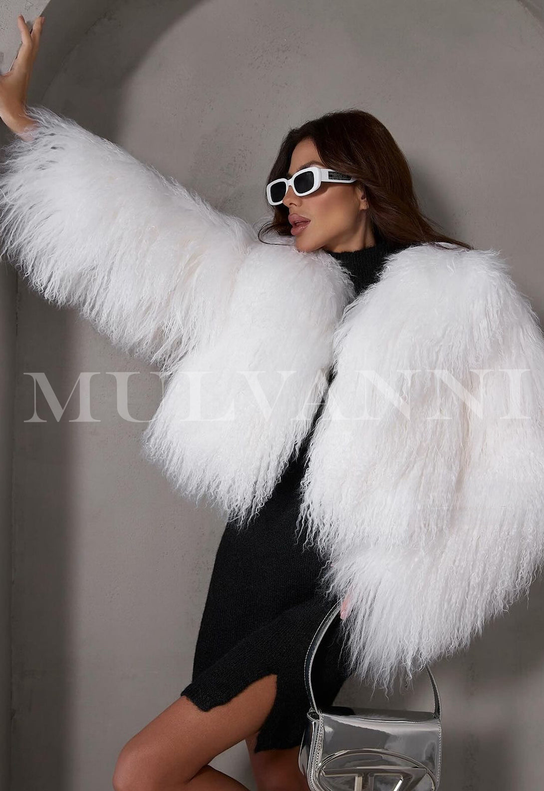 Stylish woman wearing white sunglasses and a short white mongolian fur coat. 