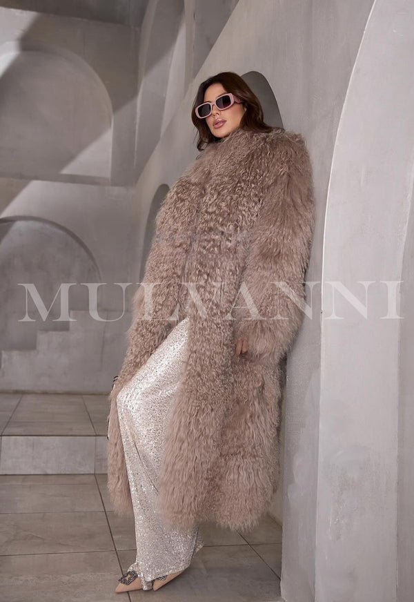 Woman wearing a trendy long light brown Mongolian fur coat perfect for winter.