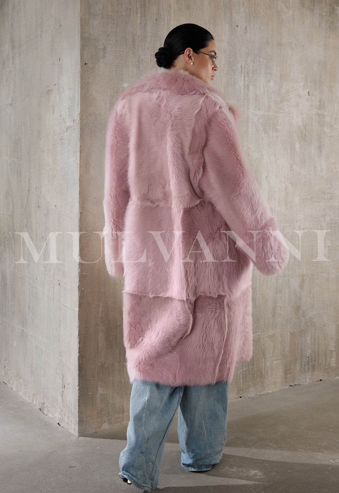 A full-length pink shearling coat for women, combining a plush, cozy interior.