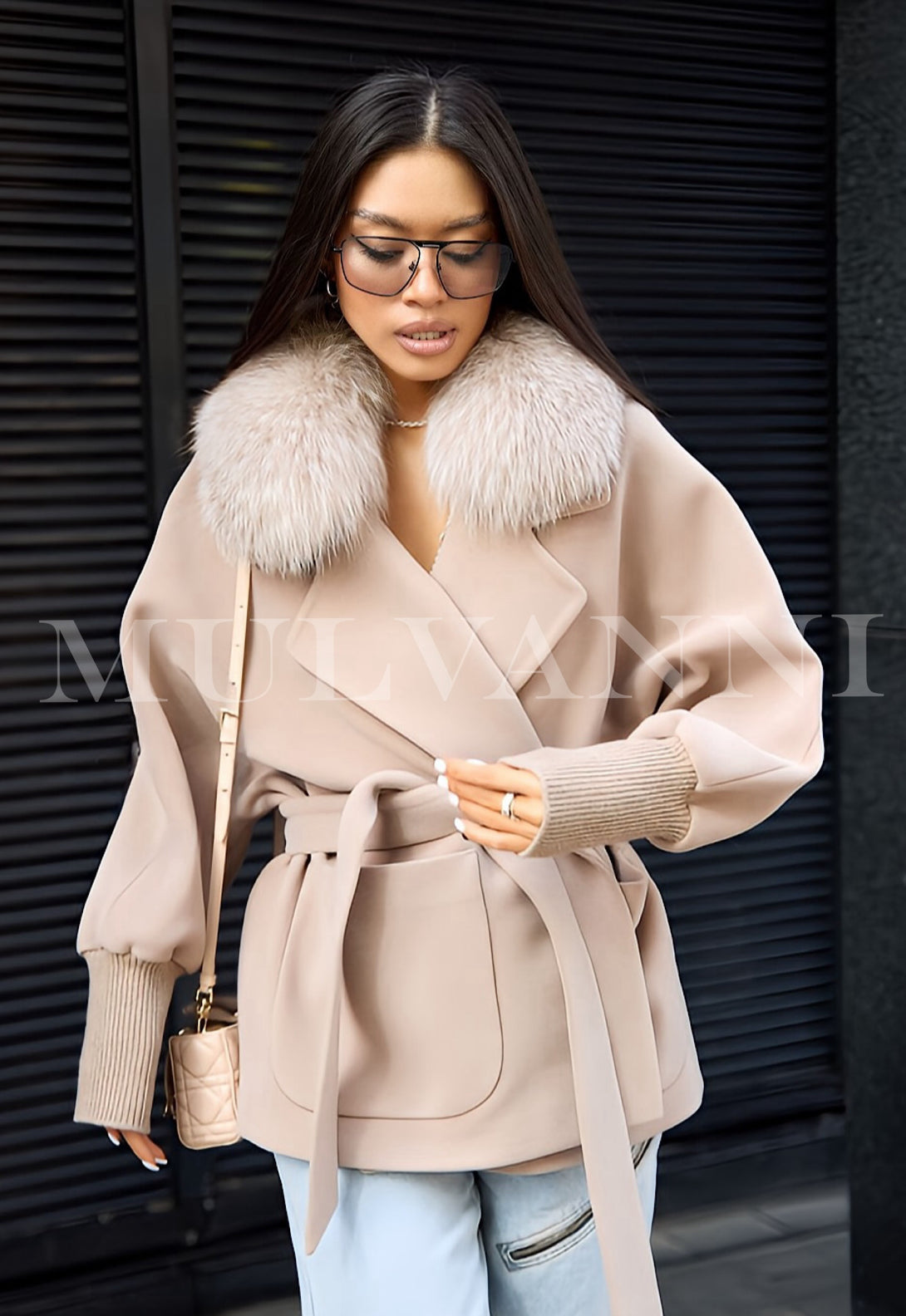 Woman wearing Limited Edition beige cashmere coat with detachable fox fur collar pairing with matching belt, exuding luxury and elegance.