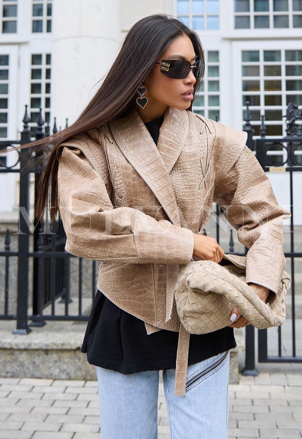 Stylish woman wearing JAKI Embossed Croc Leather Jacket in earthy tones, paired with sunglasses and a matching handbag outside.