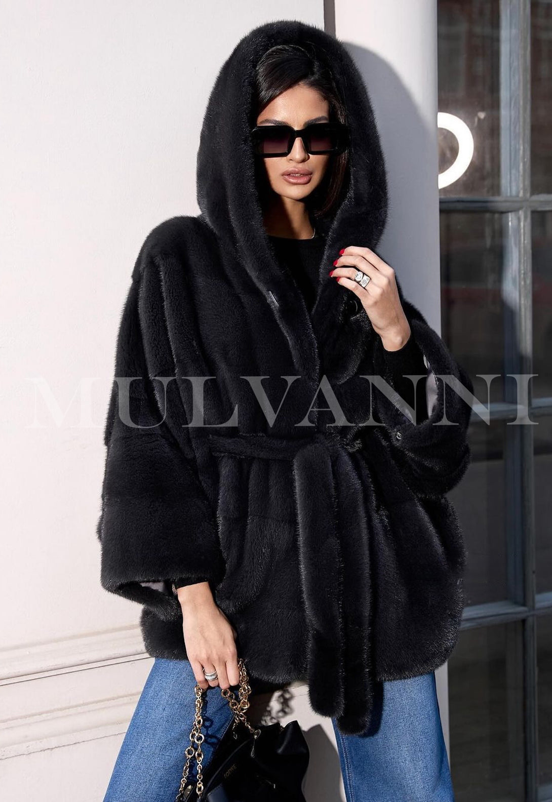 Woman wearing ALEXANDRA Hooded Mink black Coat, stylish and designer coat for women, exuding luxury and elegance