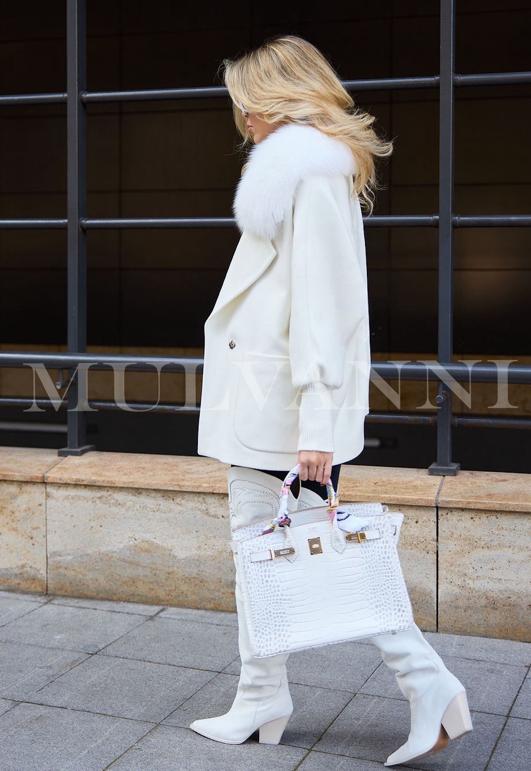 Women's loose white cashmere coat, showcasing a soft, fluffy texture with elegant fox fur embellishments. The coat features an open front and a spacious fit, making it a stylish choice for layering in winter.