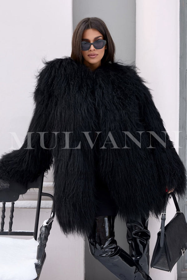 A woman wearing a trendy black Mongolian fur coat, featuring a soft, luxurious texture that is perfect for winter and autumn. The coat's stylish design and chic silhouette make it a fashionable choice for colder seasons.