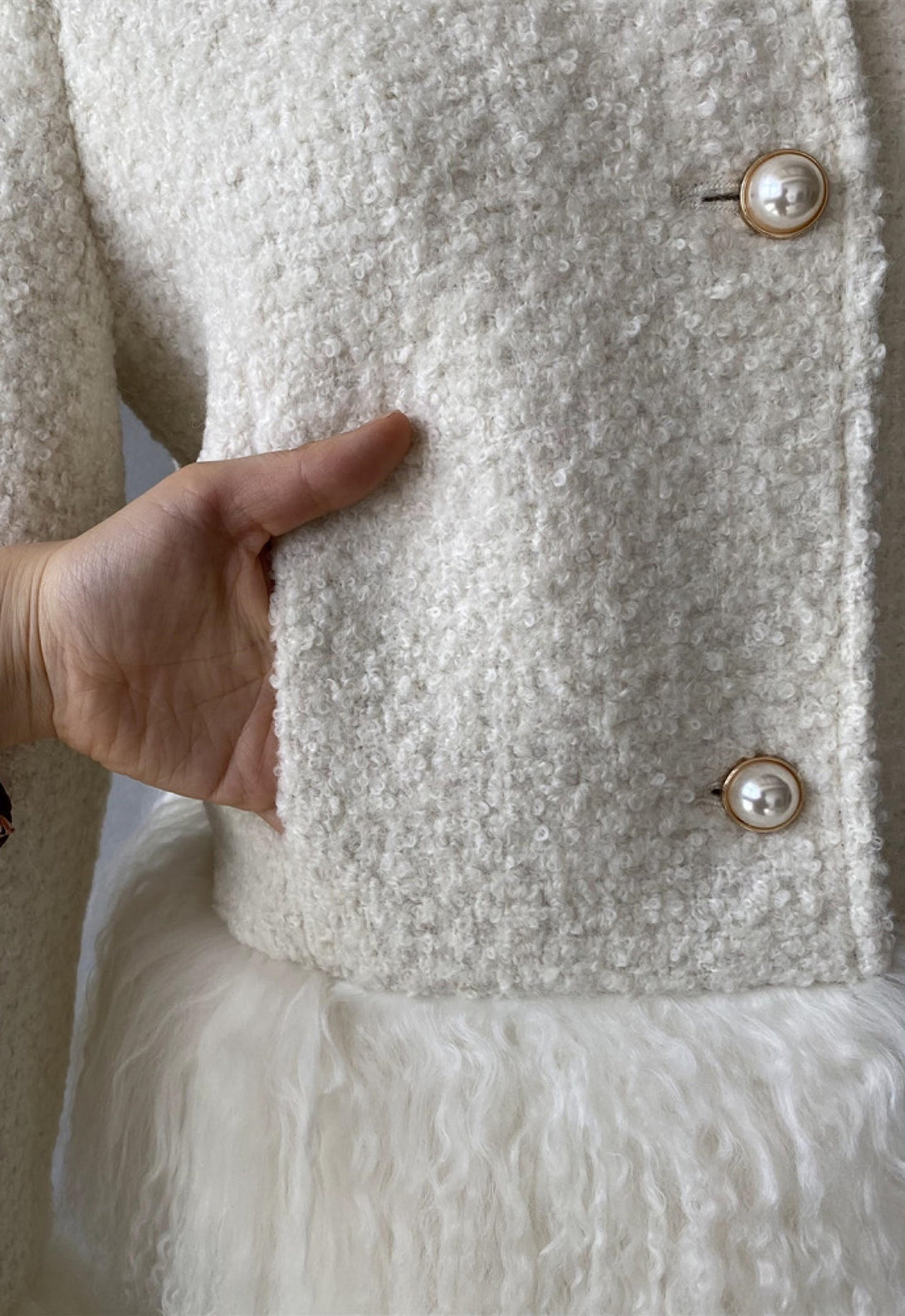 Close up from a tweed jacket for woman showcasing the high quality. 