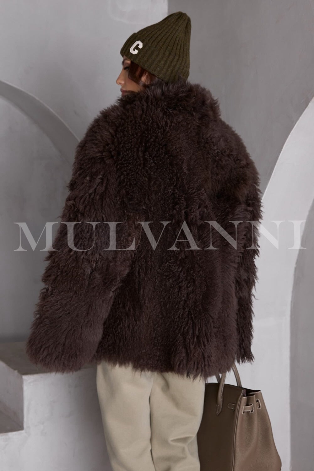 A stylish brown shearling coat for women, featuring a rich, fluffy lining and a classic design. 