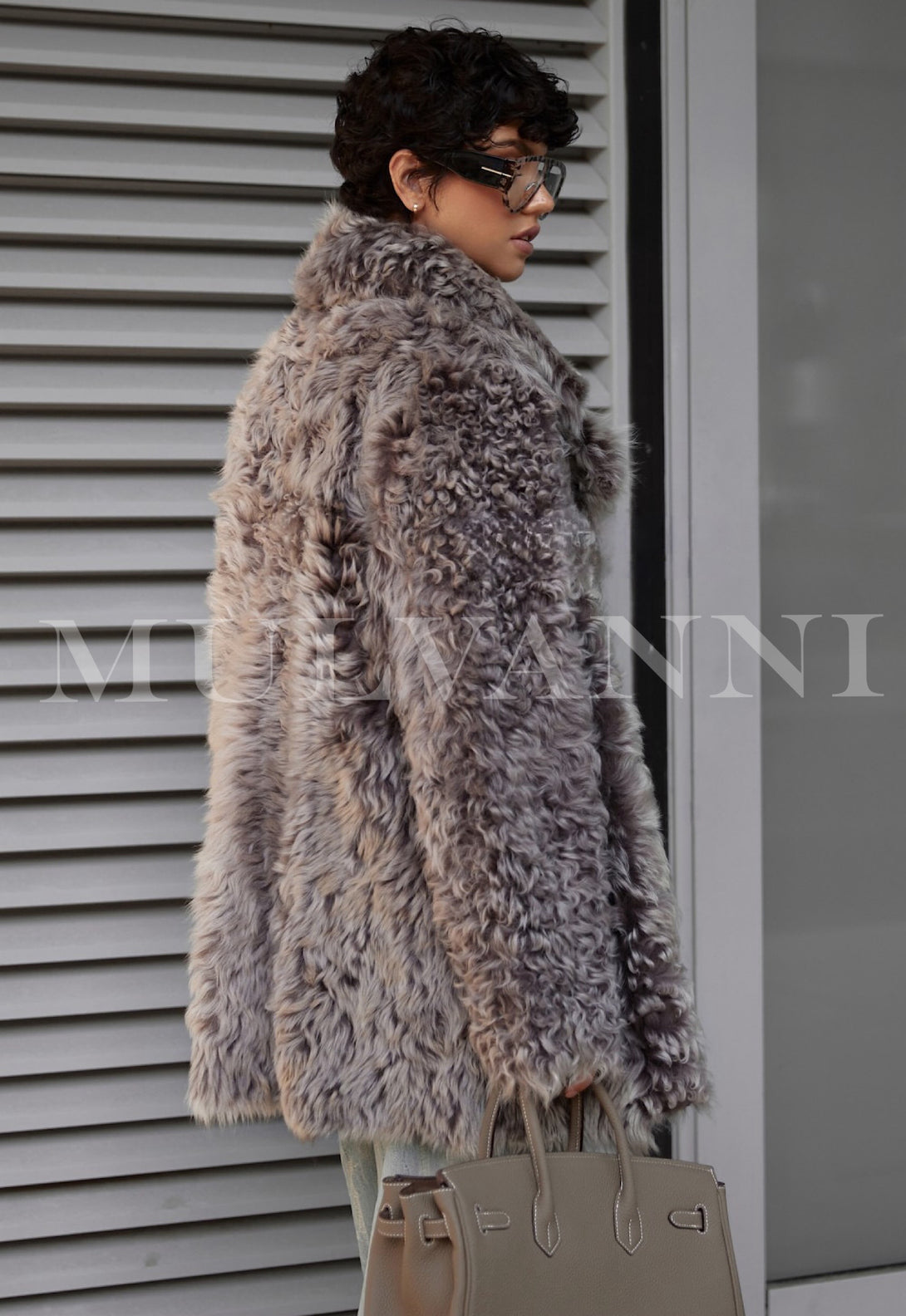 Woman wearing ADRIE Mousse Shearling Coat, showcasing luxurious, thick and soft texture, perfect for cooler weather.