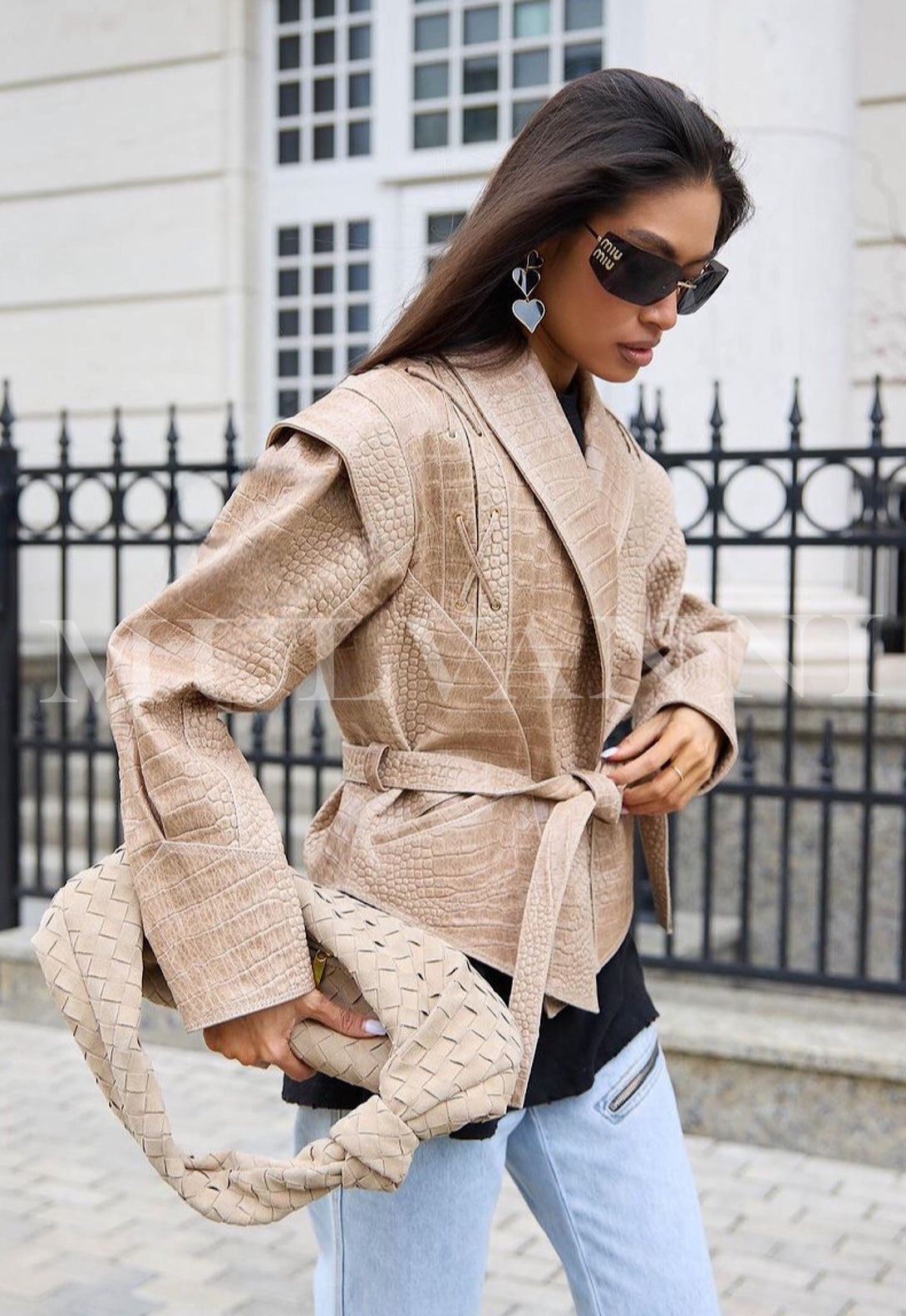 Woman wearing JAKI Embossed Croc Leather Jacket with tailored fit and carrying a woven bag