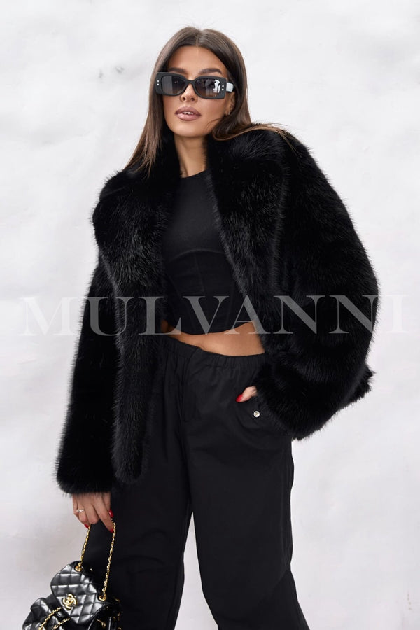 A woman wearing a soft black faux fur coat that exudes luxury, paired with stylish sunglasses. The coat features a plush texture and a chic design, creating a fashionable look for winter outings.