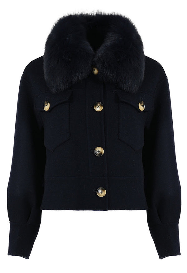 A short black cashmere coat featuring a luxurious fox fur collar and a tailored fit. The coat has a sleek design with a button closure and side pockets, combining elegance and warmth for a stylish winter look.