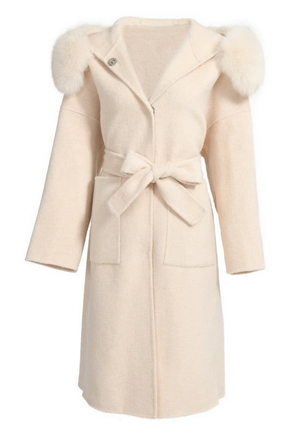 A long ivory cashmere coat featuring a cozy hood trimmed with luxurious fox fur and a stylish belt. The coat combines warmth and elegance, making it a sophisticated choice for winter wear.