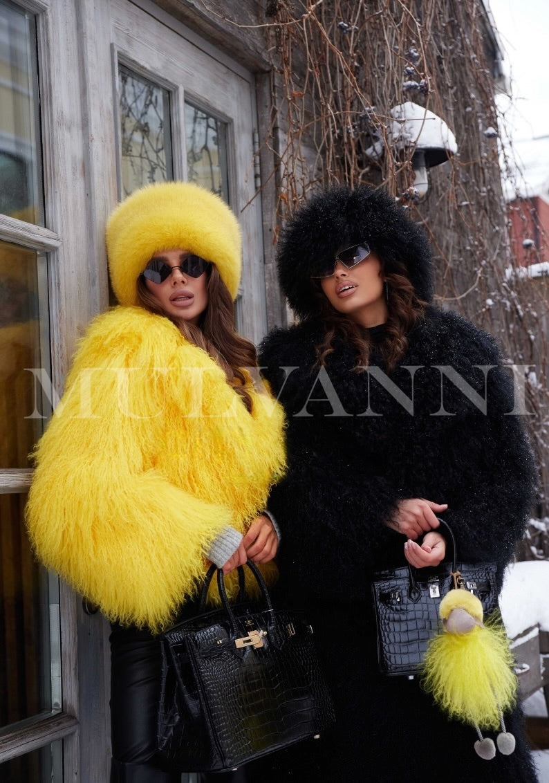 Two woman wearing Mongolian fur coats in yellow and black, stylish and chic coats. 