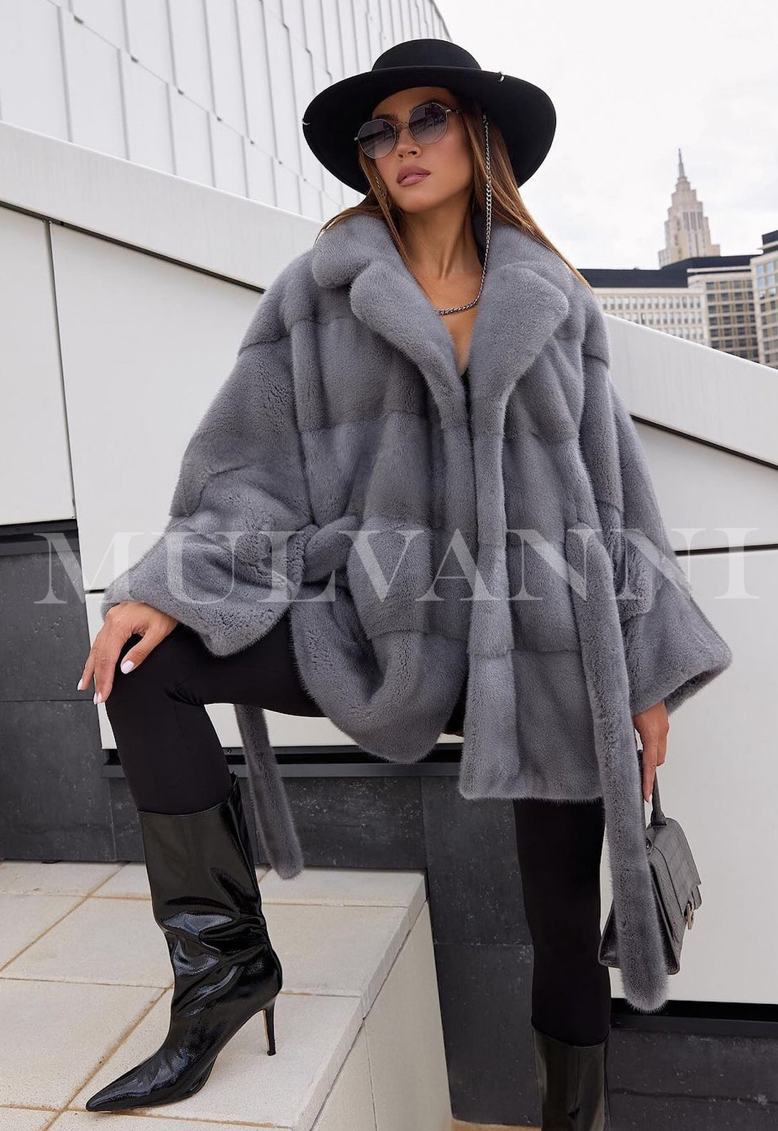 Women's grey mink short coat with a soft, velvety feel and a belted waist for a tailored fit. The coat has a classic collar, cropped length, and a refined look, perfect for adding a touch of luxury to any outfit.