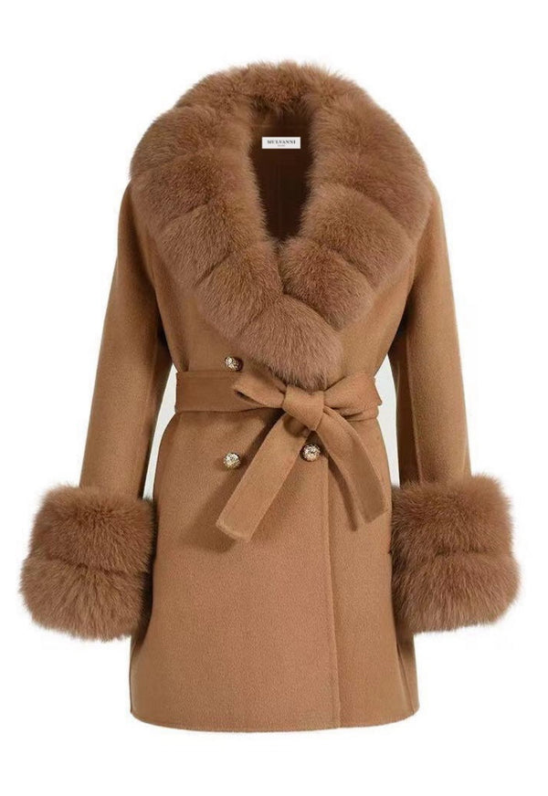 A woman wearing a chic short camel cashmere coat, featuring luxurious fox fur accents and elegant gold buttons, perfect for a refined and stylish look.