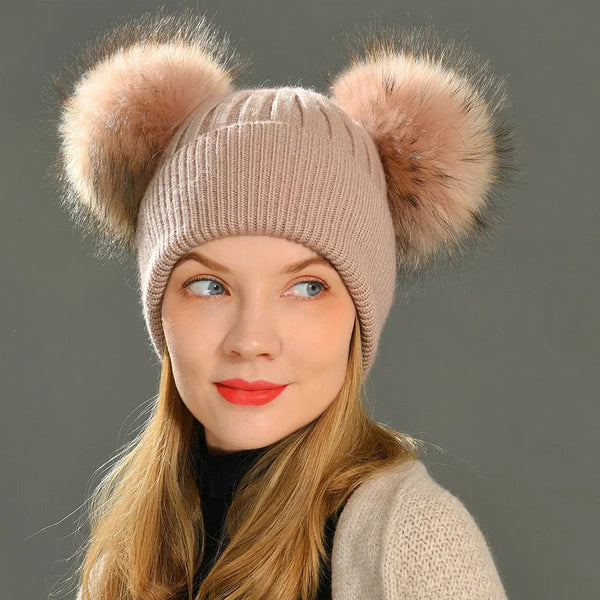 A woman wearing a  pink fur hat beanie designed by MVFURS 