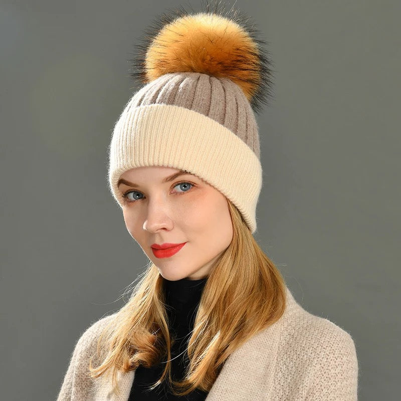 A woman wearing a fur cashmere beanie. 